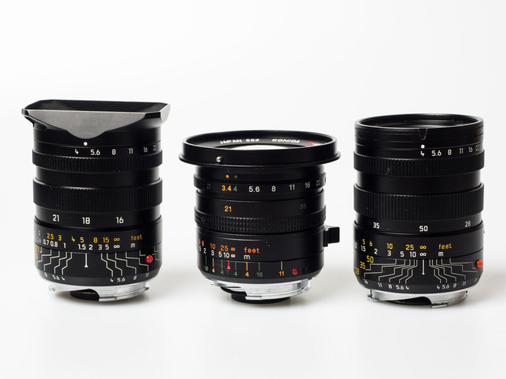 Produktfoto Leica Tri-Elmar 1:4/16-18-21 ASPH (WATE) und Leica Tri-Elmar 1:4/28-35-50 (MATE) sowie Konica M-Hexanon Dual 1:3.4-4/21-35